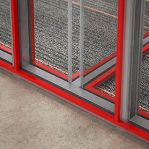 Framed-Glass-wall-partions-with-red-powder-coat-reveal-with-frameless-sliding-doors-2